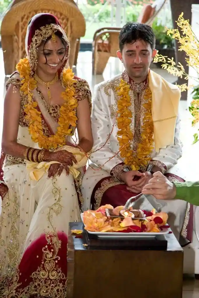 Destination wedding couple participating in traditional wedding ceremony